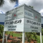 Installed V-shape Cushman and Wakefield Sign with Posts
