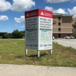 Installed Cushman and Wakefield 4x4 V-shape Sign with Posts